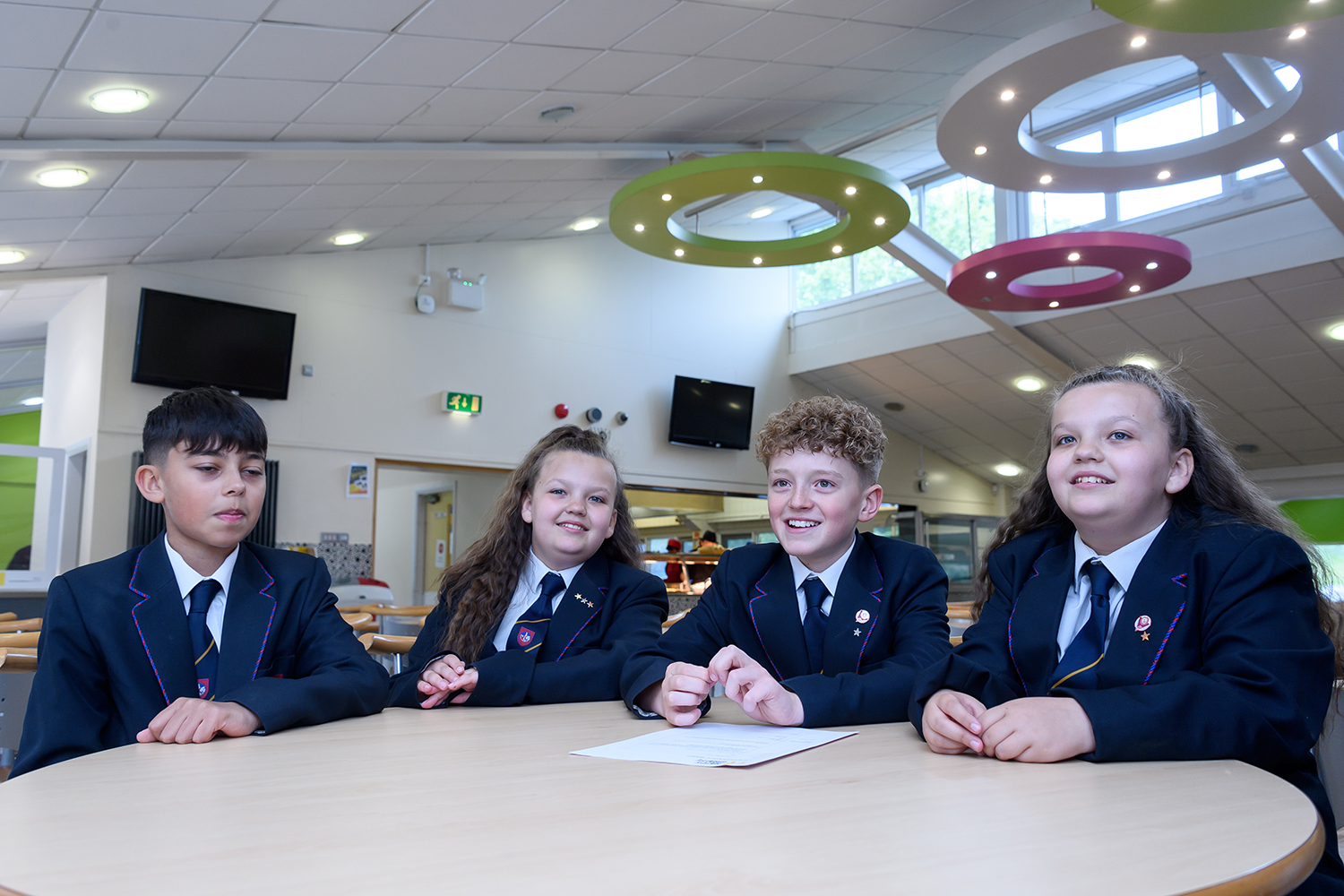 Four students sitting in school cafeteria